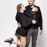 An adult wearing the Love Radius Parent Hoodie in Black