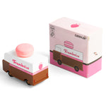 Picture of the Framboise Candylab Candyvan. with its box. It is a 1960s style brown and white van with a pink Raspberry Macaron on the roof.