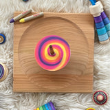 The Mader DIY Spinning Top Discs, coloured in so create a swirl pattern, and spinning on a Mader spinning plate.