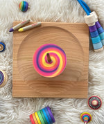 The Mader DIY Spinning Top Discs, coloured in so create a swirl pattern, and spinning on a Mader spinning plate.