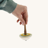 A hand holding the Mader 'So And So' DIY wooden spinning top