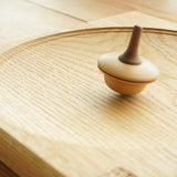 Mader wooden duet spinning top toy on a Mader wooden spinning plate