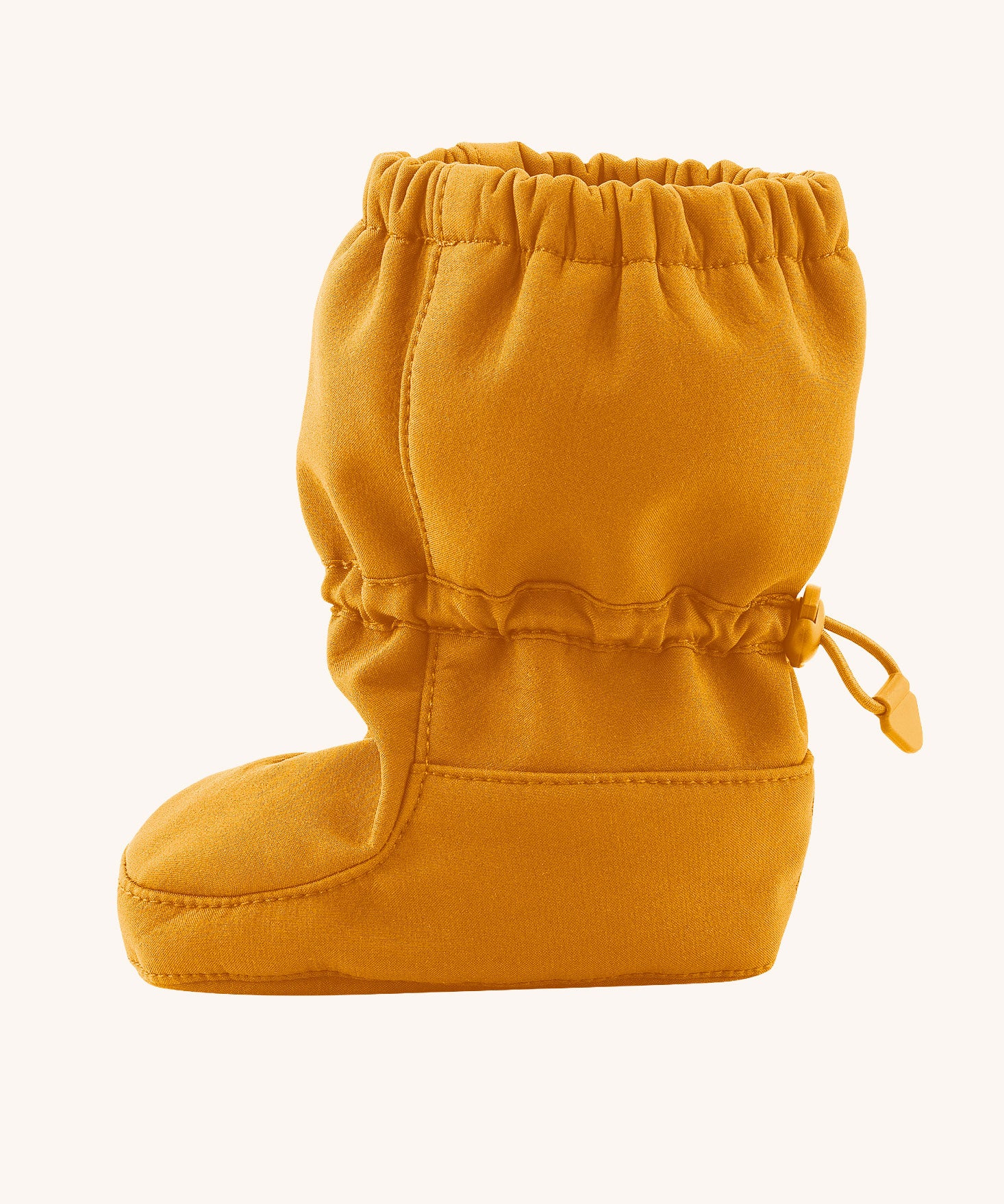 Side image of the Mamalila toddler allrounder winter booties in the mustard yellow colour available at Babipur showing the elasticated ankle cuff detail