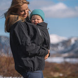 A person wearing the Mamalila Outdoor Explorer Babywearing Jacket - Mint