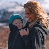 A person wearing the Mamalila Outdoor Explorer Babywearing Jacket - Mint