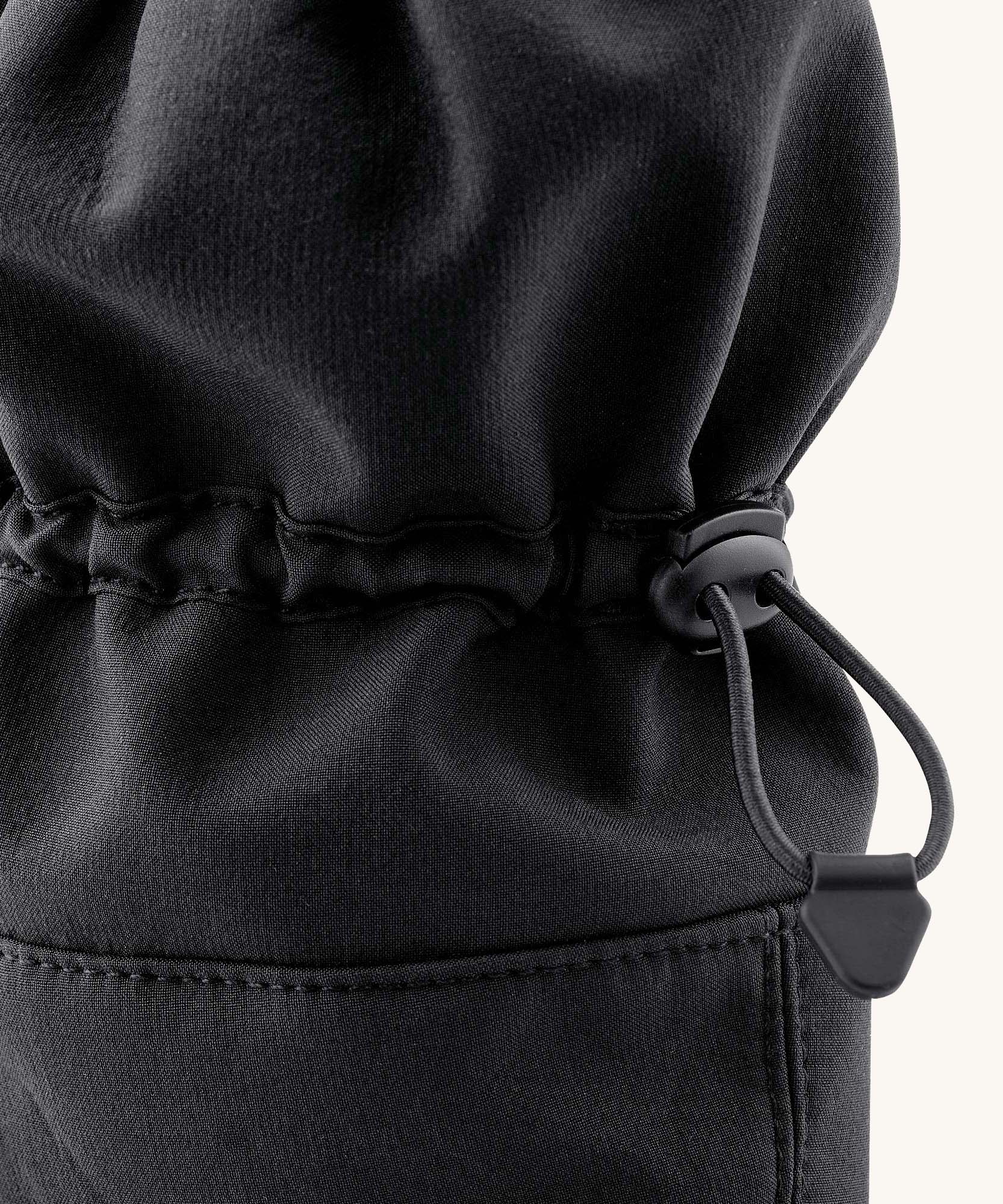 Closeup of the elasticated fastening on the Mamalila Allrounder Softshell waterproof babywearing booties in black