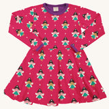 Maxomorra Fairy Long Sleeve Circle Dress on a plain background. The dress features an all over fairy print on a hot pink colour background with contracting purple coloured collar and sleeve binding trims.
