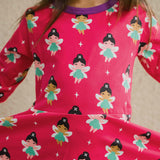 A close up of a child wearing the Maxomorra Fairy print circle. dress.