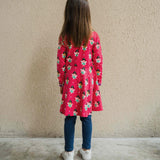 A child wearing the Maxomorra Fairy print circle dress. The child is facing away from the camera showing the back of the dress.