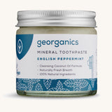 A jar of the Georganics English peppermint mineral toothpaste on a cream background.