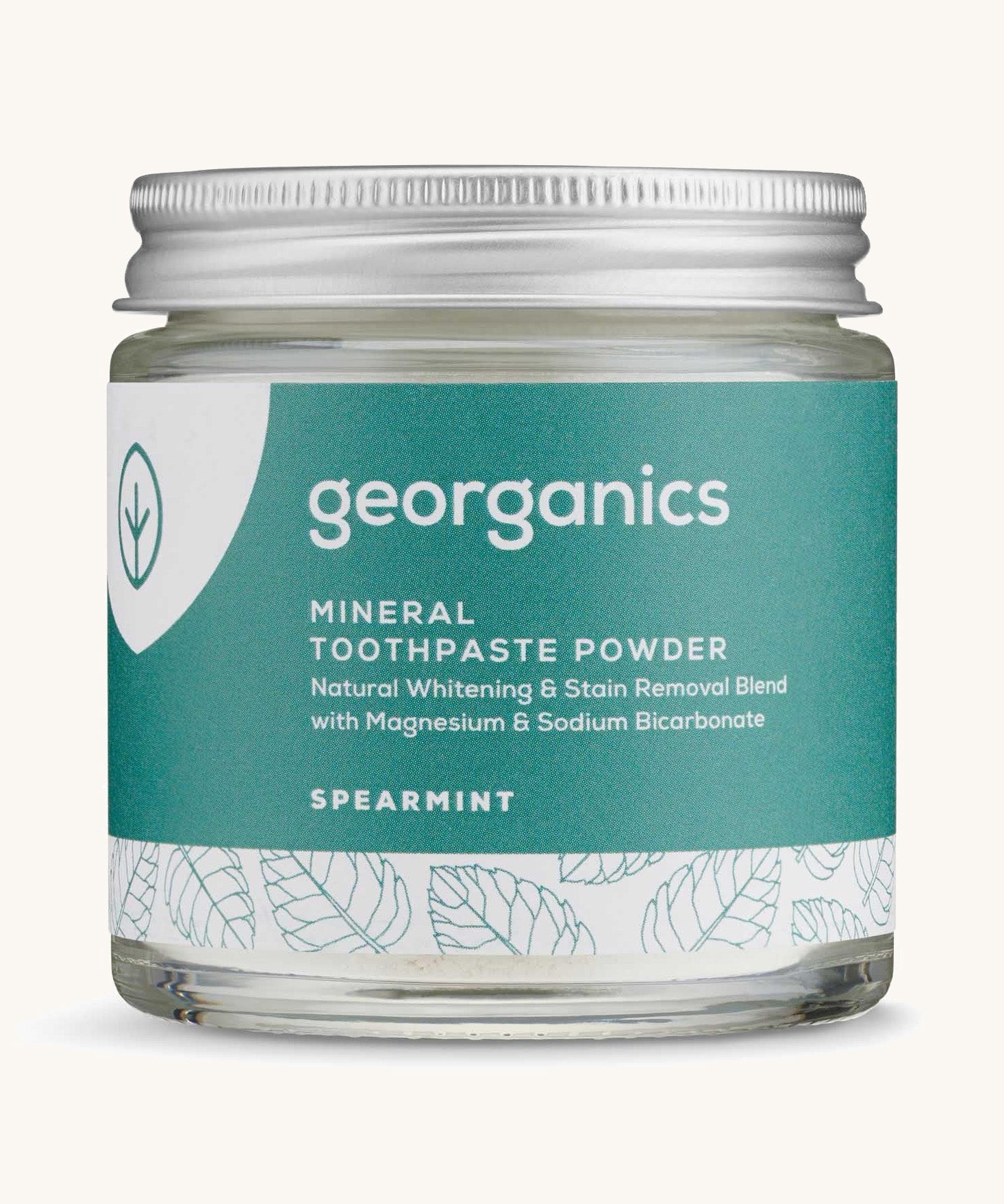 A jar of the spearmint Georganics toothpaste powder on a cream background