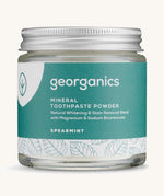 A jar of the spearmint Georganics toothpaste powder on a cream background