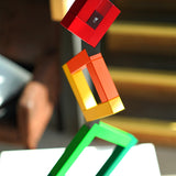 Close up of Naef Angular construction toy showing the black connector piece helping the structure balance.