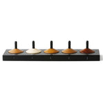 Naef 5 eco-friendly wooden spinning top toy set in their black stand on a white background