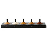 Naef 5 eco-friendly wooden spinning top toy set in their black stand on a white background