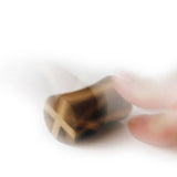 Blurred picture of a hand spinning the Naef tip spinning tops on a white background
