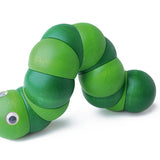 Green Naef Juba worm toy laying on a white background.