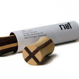Naef premium wooden spinning top blocks next to their white tube packaging on a white background