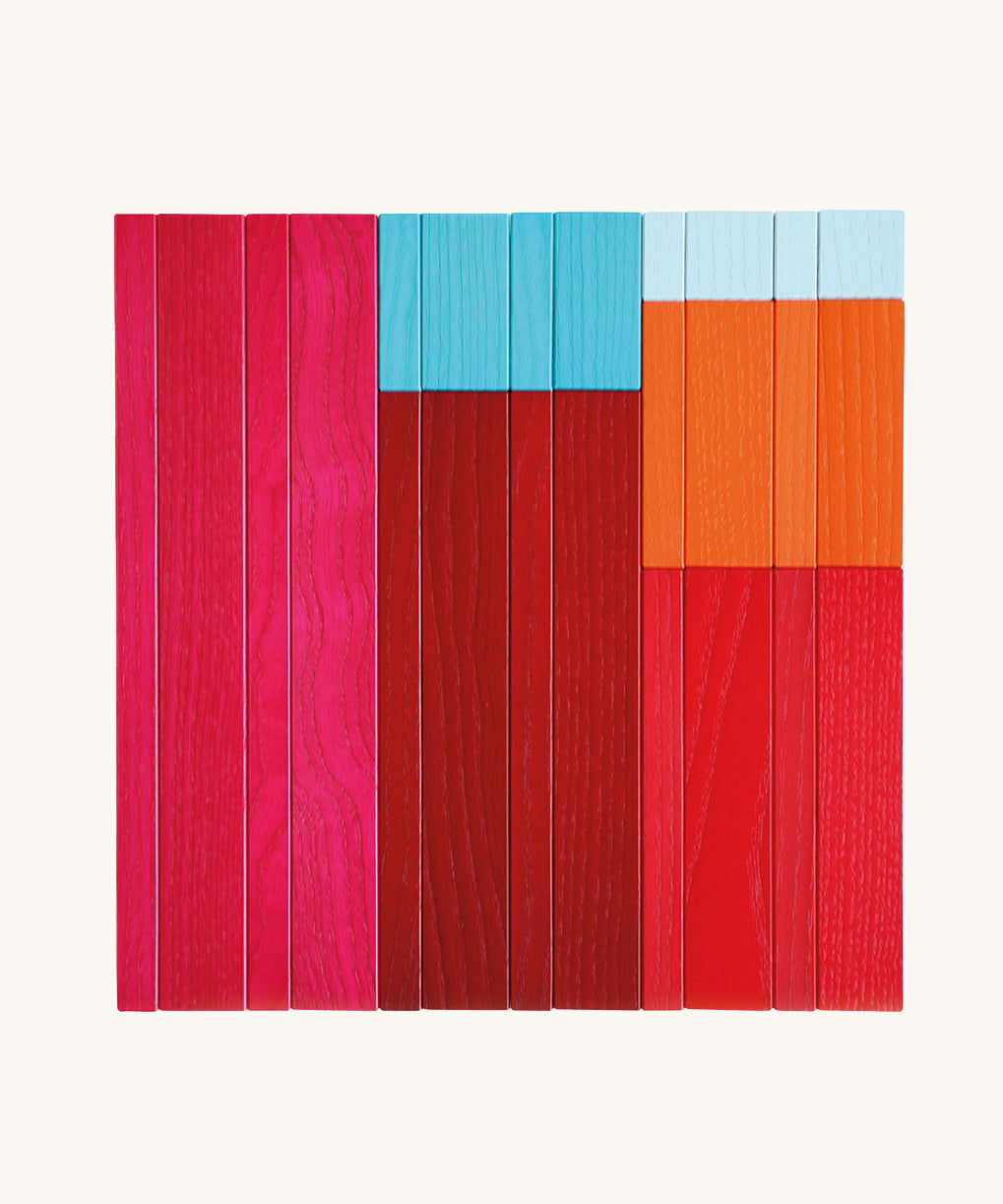 Flat lay of Naef Tigno coloured wooden blocks arranged by size and shade. Premium precision cut German wooden puzzle pieces made from ash wood.