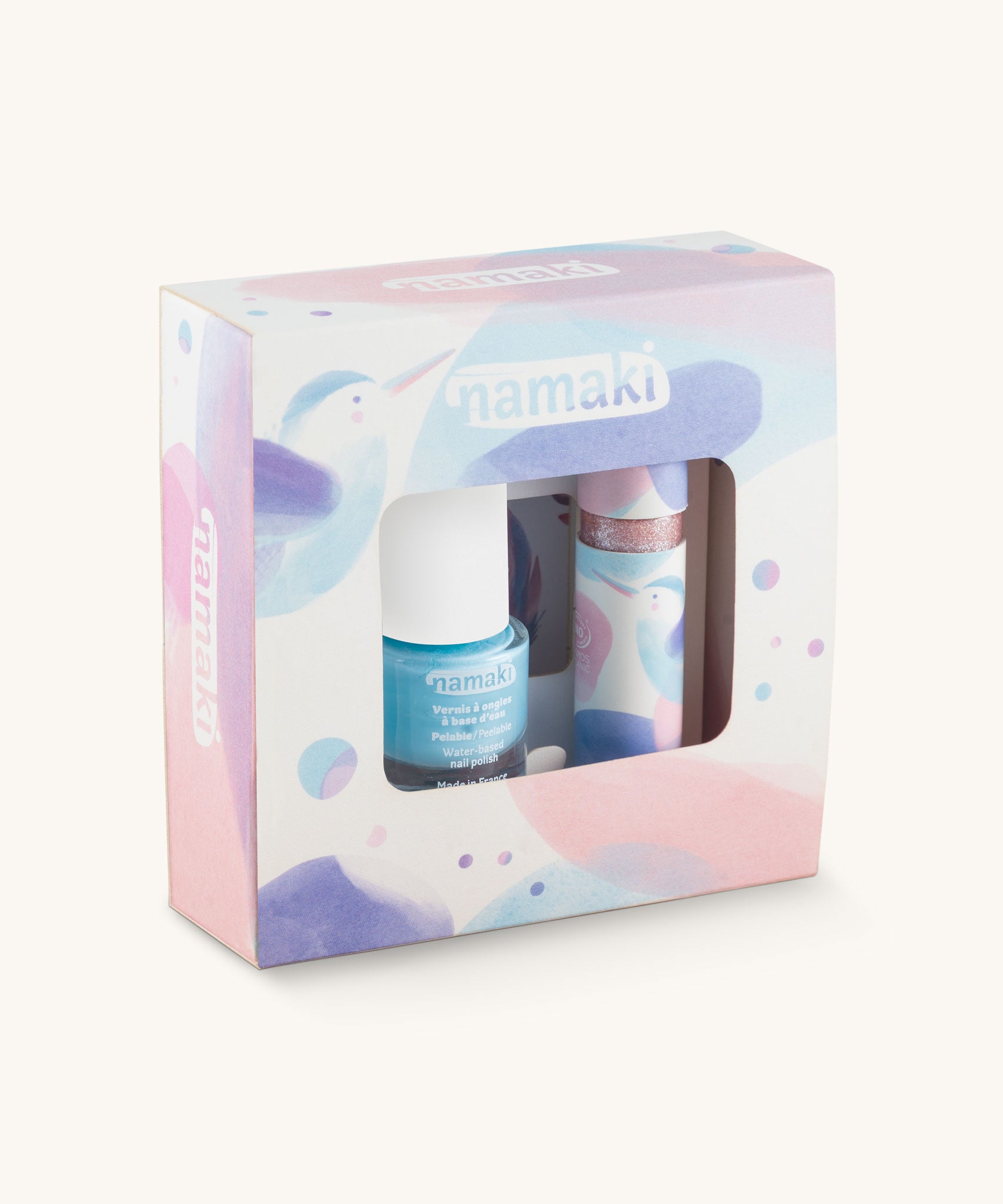 Namaki Hummingbird Trio Children's beauty Gift Set. The set contains a blue coloured nail polish, a sheet of tatoos and a lip gloss. Namaki have a range of natural and organic face paint sets and makeup for kids available at Babipur.