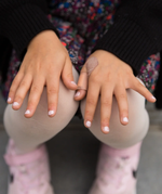 A closes up of a child's hands, with painted nails using the Namaki non-toxic child-safe nail varnish from the makeup gift set.