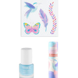 The contents of the Namaki Hummingbird makeup trio giftset at Babipur; a non-toxic blue nail polish, a sheet of temporary tattoos, a natural and organic lip gloss.