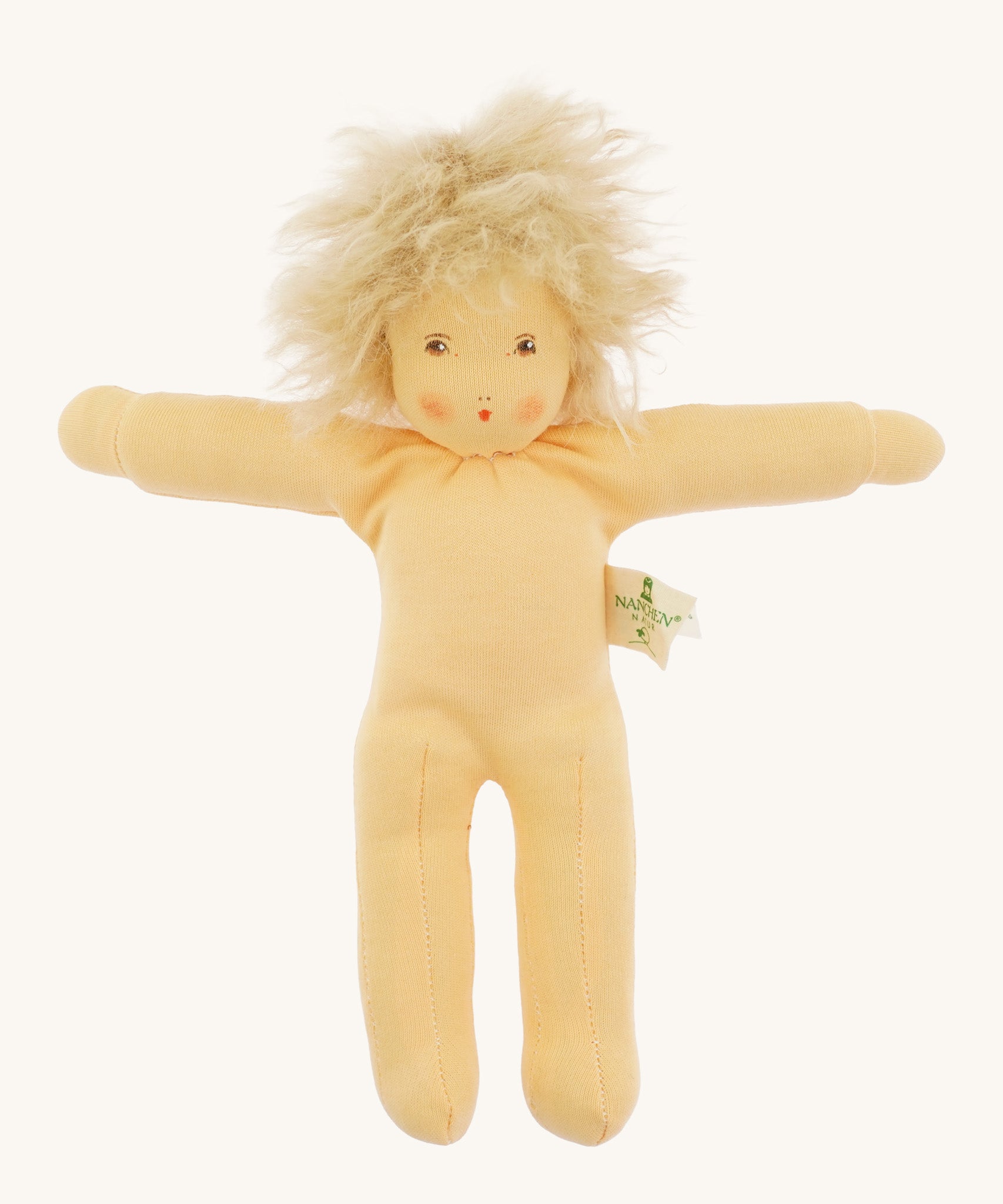 Full view of the same pale-skinned Nanchen organic Waldorf doll with unruly platinum blond hair, shown unclothed to reveal the simple soft fabric body.