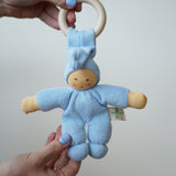 A light blue Nanchen Pimpel Waldorf Doll Ring Comforter toy being held in an adult's hands.