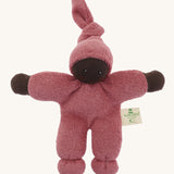 A Nanchen Pimpel Waldorf Handcrafted Doll with a berry pink coloured outfit an matching knotted hat. The doll has dark brown coloured skin.