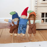 Three Nanchen Waldorf dolls lined up. Bela blueberry, Frederik and  Otto Orange. The dolls all have removable outfits and hats. The Plan Toys Victorian dolls house can be seen in the background.