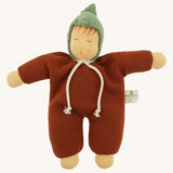 Front view of the Nanchen Waldorf Walnut Baby Doll. The doll wears a warm brown organic cotton terry suit with a green pointed hood and a white tie at the neck. Its soft face features hand-painted sleeping eyes, rosy cheeks, and a small pink mouth.