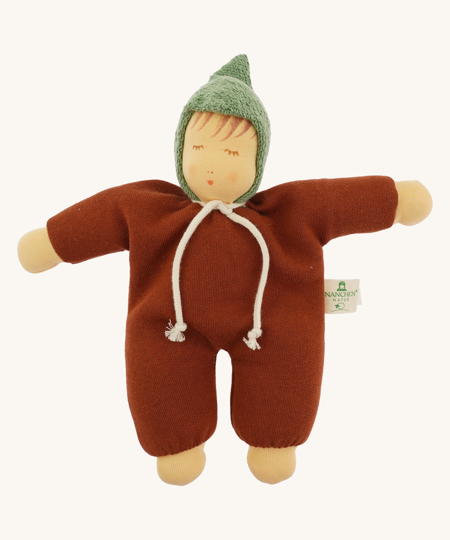 Front view of the Nanchen Waldorf Walnut Baby Doll. The doll wears a warm brown organic cotton terry suit with a green pointed hood and a white tie at the neck. Its soft face features hand-painted sleeping eyes, rosy cheeks, and a small pink mouth.