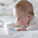 A baby looking down at the Lavender Green People Baby Wash & Shampoo