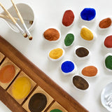 Close up of some pebbles painted in white and coloured Natural Earth eco-friendly paints