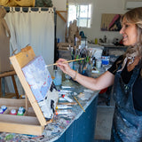 An artist in the studio painting on a canvas using the Natural Earth Pain natural acrylic paints