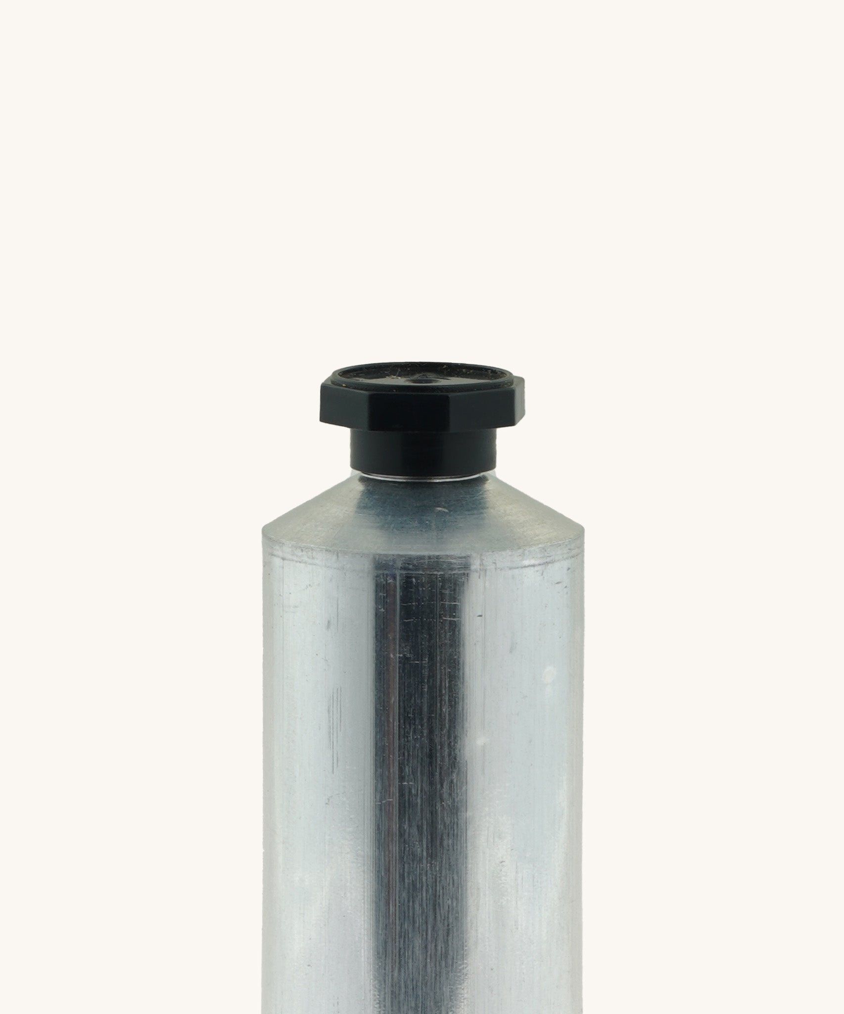 A close up of the blank flexible aluminium tube from Natural Earth Paint showing the detail of the black screw cap