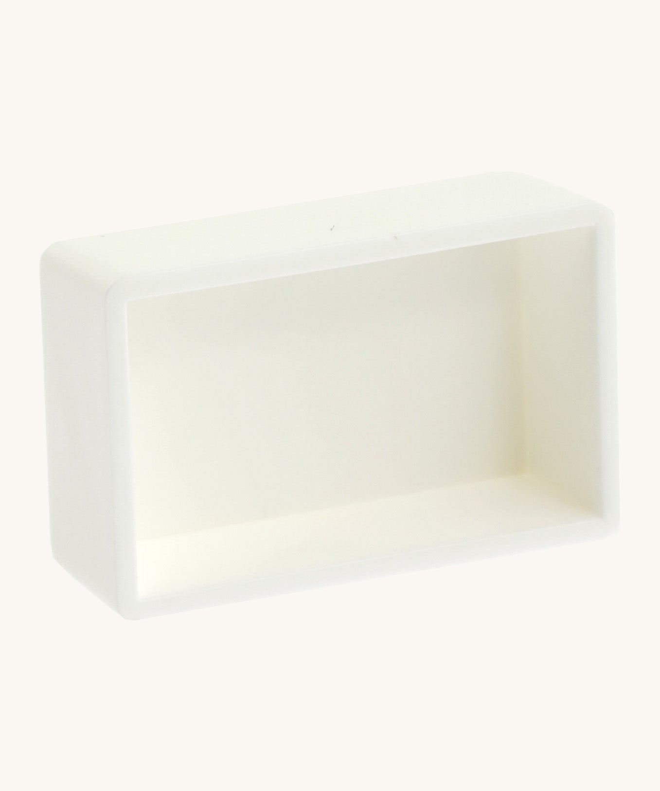 A blank white watercolour paint pan from Natural Earth Paint showing the space inside to hold a mix of homemade paint