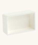 A blank white watercolour paint pan from Natural Earth Paint showing the space inside to hold a mix of homemade paint