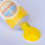 A close up of the brilliant yellow paint from Natural earth paint aluminium tube showing the consistency