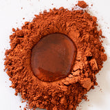 Natural Earth Paint rust brown pigment paint with a droplet of binder ready for mixing.