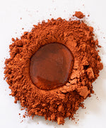 Natural Earth Paint rust brown pigment paint with a droplet of binder ready for mixing.