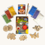 Natural Earth Paint Nature Craft Paint Kit. The contents of the kit are shown around the box and contains wooden shapes, brushes and paint powders.
