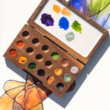 Natural Earth Paint small wooden watercolour palette that can open and close. Features 18 paint wells a and a mixing area