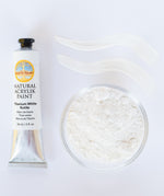 A top down view of the Natural earth paint in titanium white rutile next to the white paint pigment powder and 2 streaks showing the consistency.