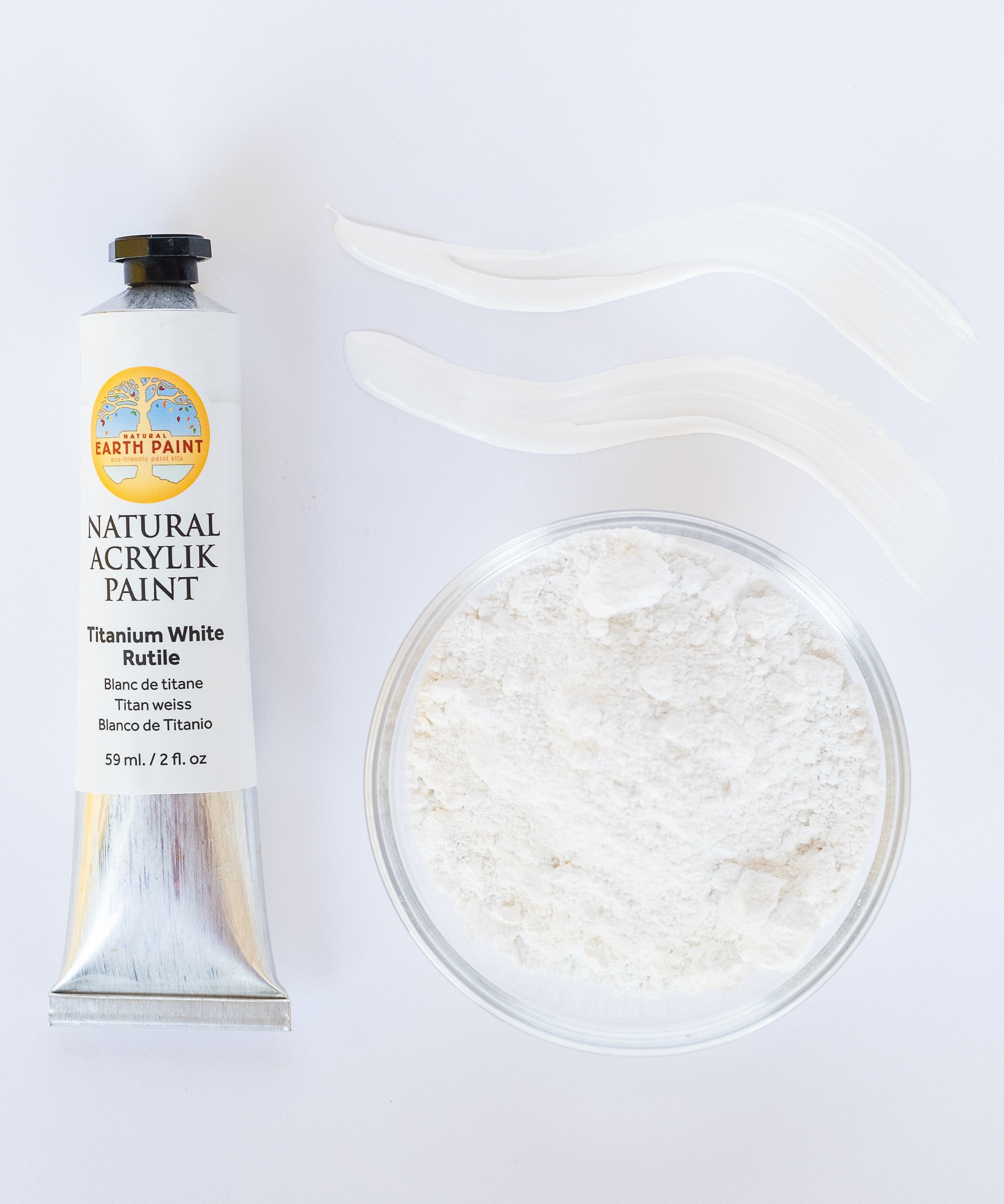 A top down view of the Natural earth paint in titanium white rutile next to the white paint pigment powder and 2 streaks showing the consistency.