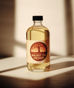 A 8oz jar of Natural Earth Paint walnut oil medium on a wooden surface - a binder to mix with the Earth & Mineral Pigments