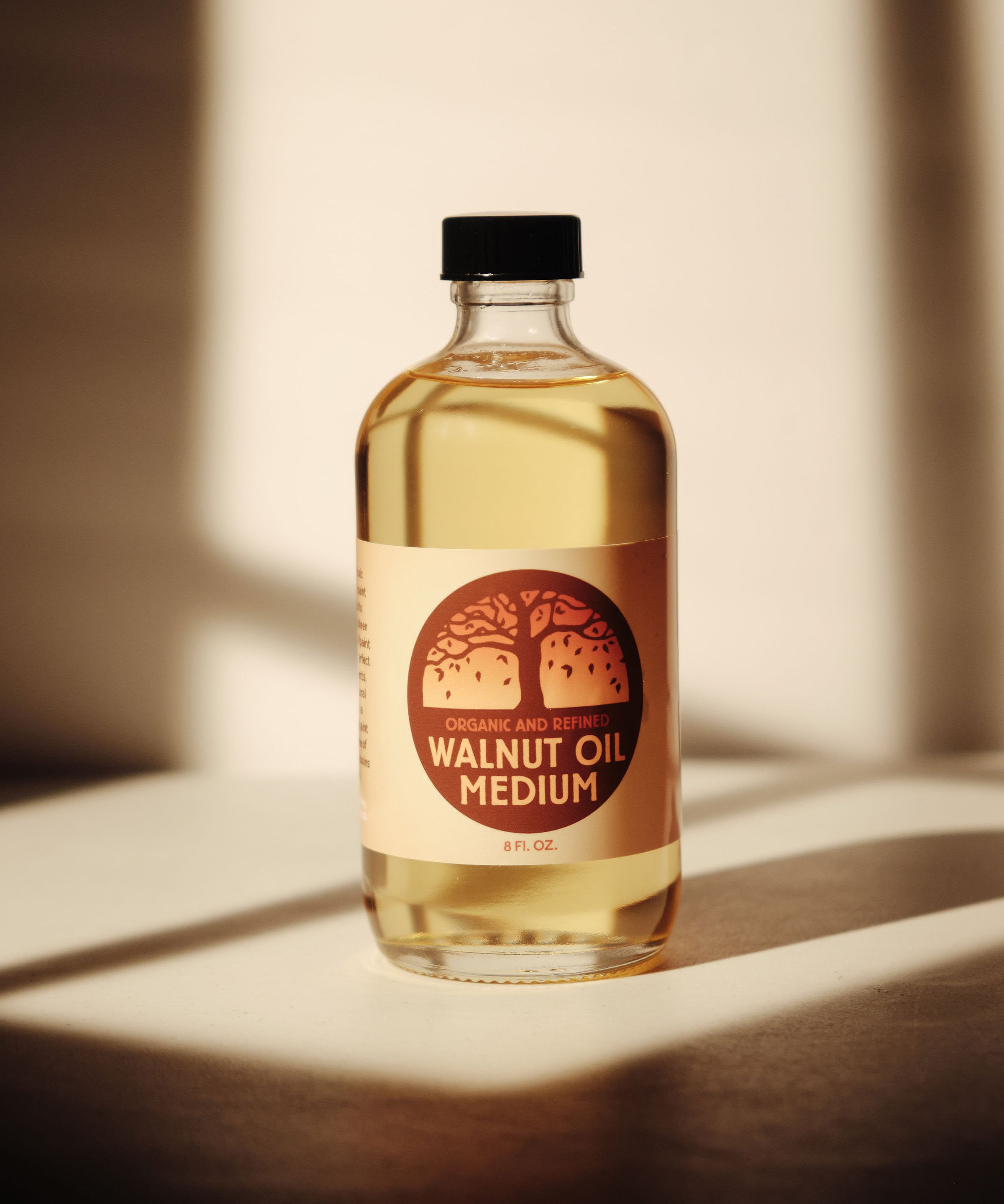 A 8oz jar of Natural Earth Paint walnut oil medium on a wooden surface - a binder to mix with the Earth & Mineral Pigments