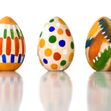 Image of three wooden eggs from the kit painted pictured on a plain white background