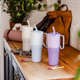 Three Klean Kanteen Limited Edition 36oz Rise Tumbler placed on a wooden counter