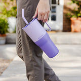A close up of a person holding the orchard bloom coloured Klean Kanteen Limited Edition 36oz Rise Tumbler in their hand